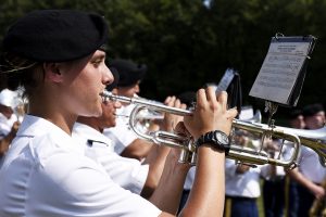 close up on band camp member playing trumpet