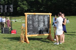 chalk board with tournament standings at 4th annual croquet on the green