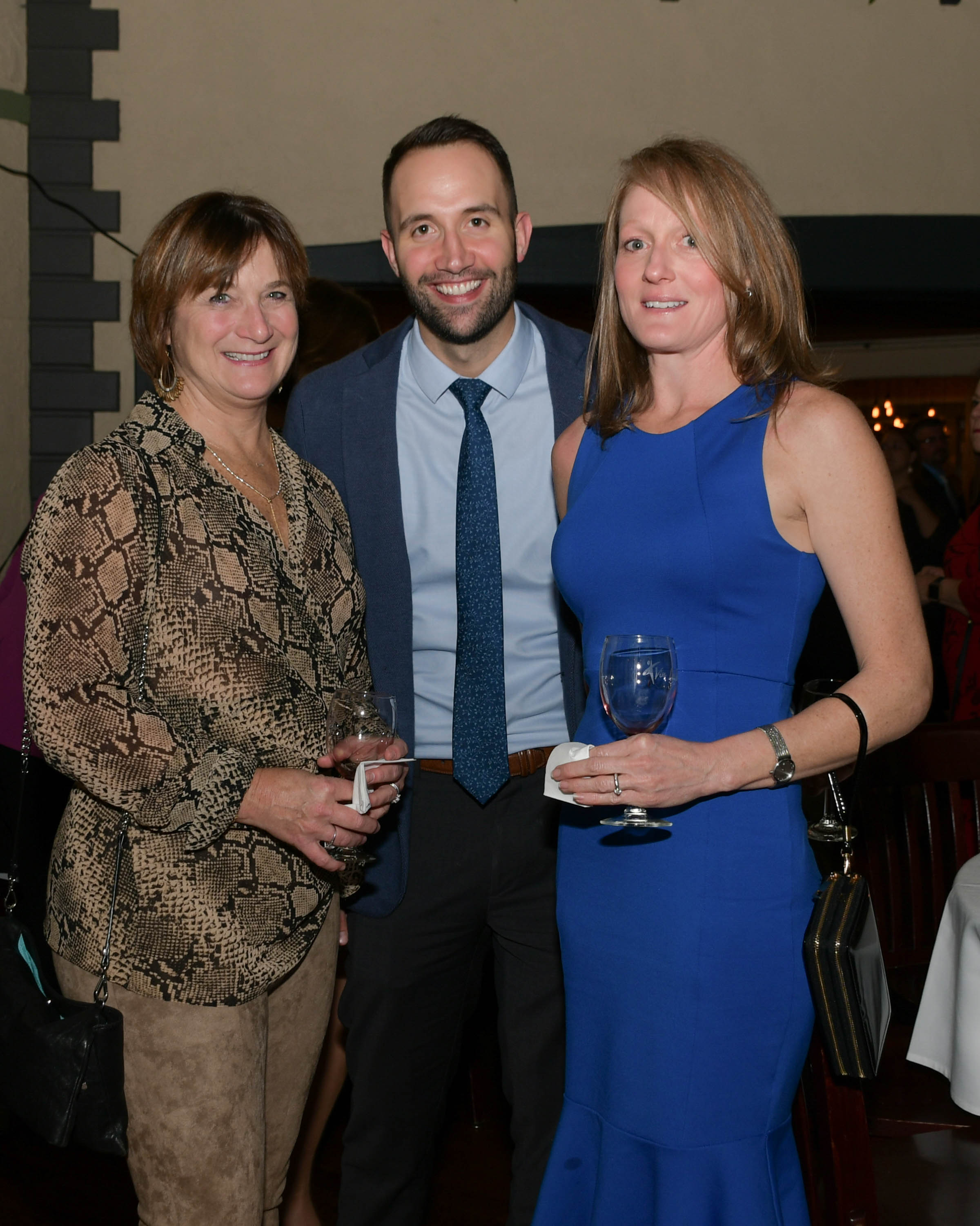 Vin Le Soir to benefit AIM Services, Inc. three people with wine