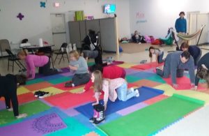group of young kids doing yoga